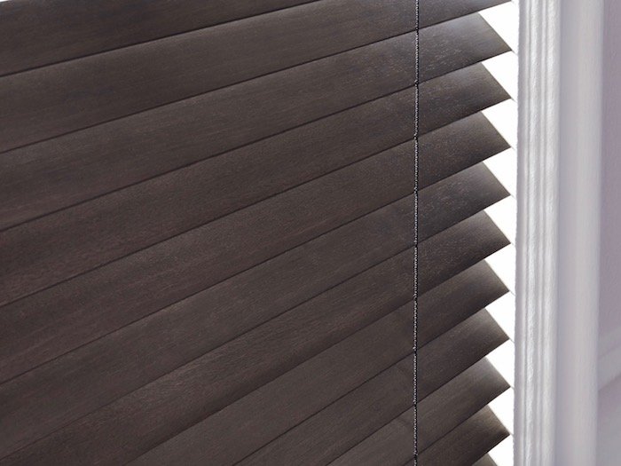 The de-Light feature on these Parkland® Wood Blinds eliminates light spots